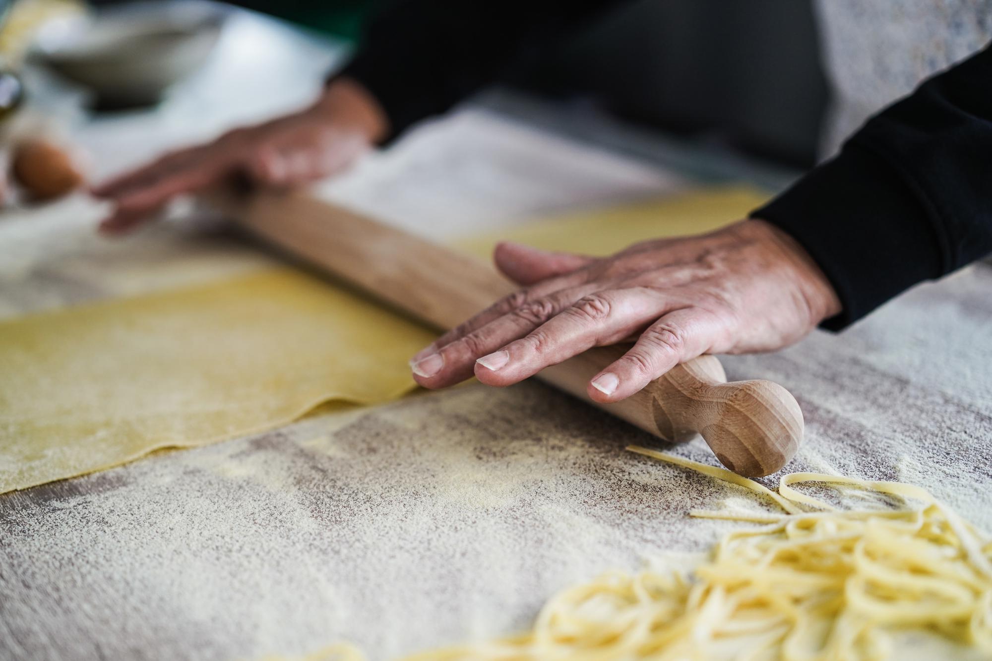 Close-up hands preparing handmade pasta